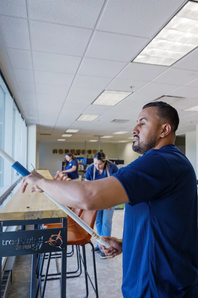 An ExtraClean team member cleaning a window in an office