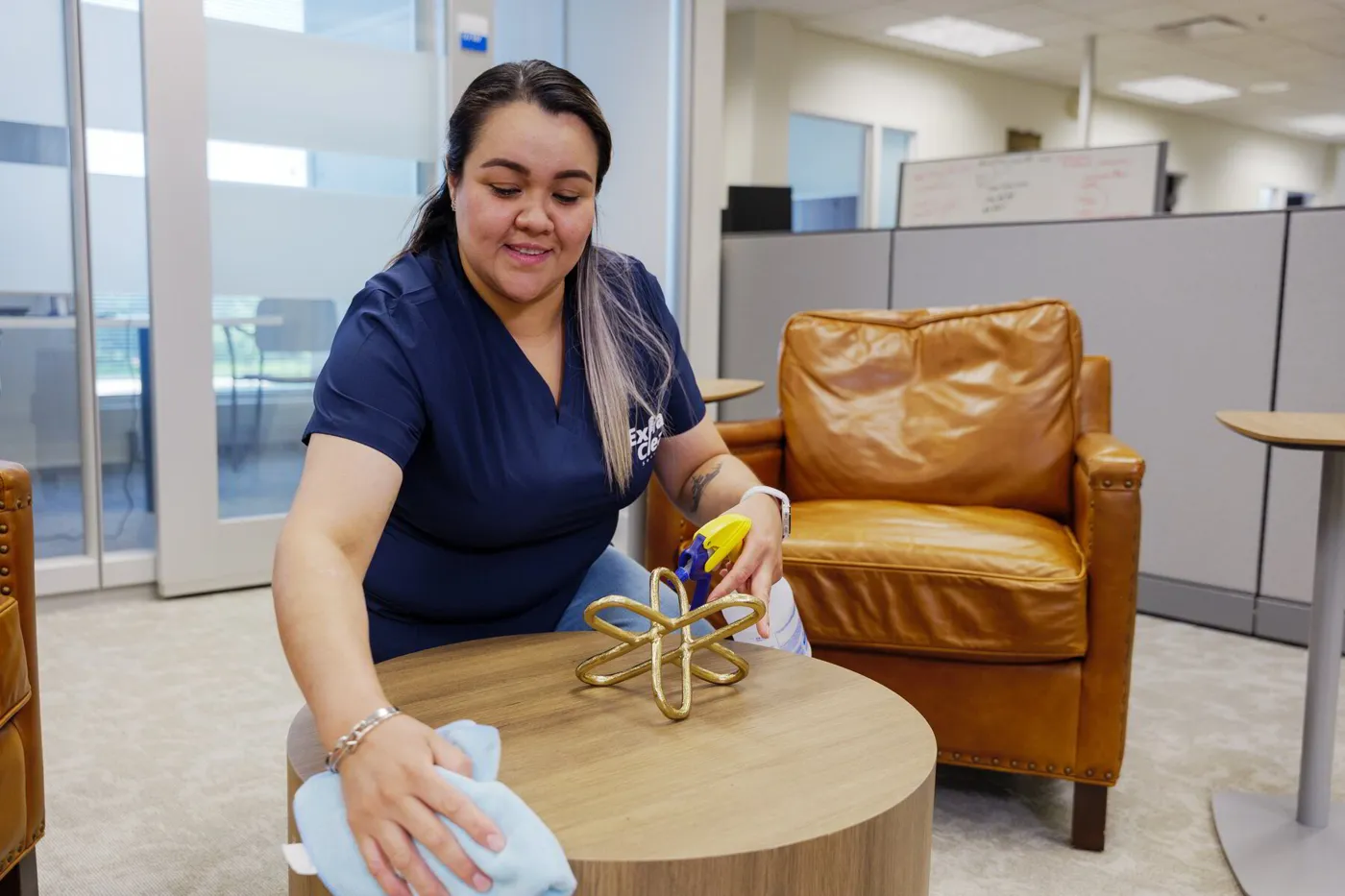 An ExtraClean team member wiping a table